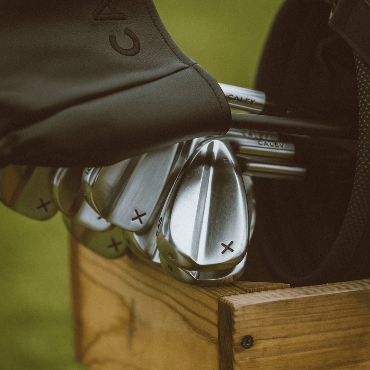 Caley irons sitting in a golf bag on the course